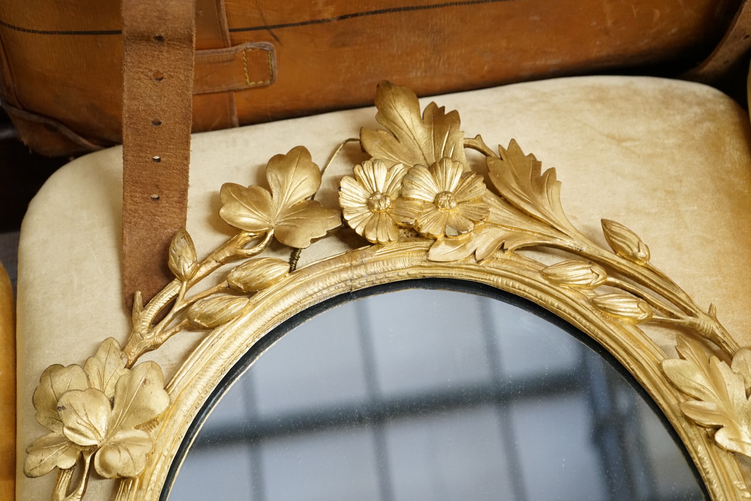 A Victorian oval carved giltwood wall mirror, width 49cm, height 66cm